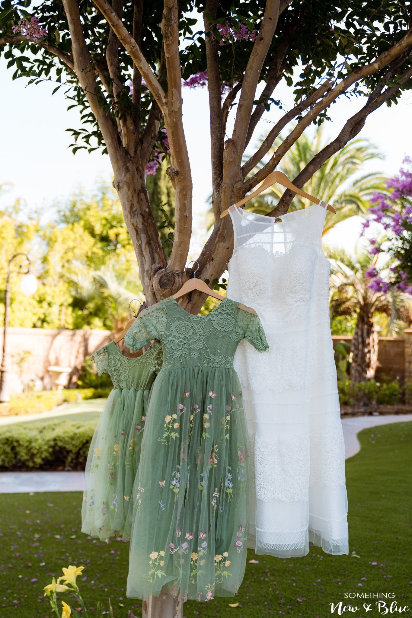 Jaclyn by a window while her dress is fastened